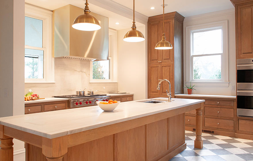 Beautiful white oak kitchen perfectly complemented with white counters and gold hardware