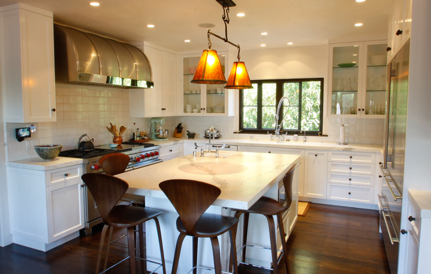 Brilliant white cabinetry is accented with a touch of metal and dark wood accessories. 