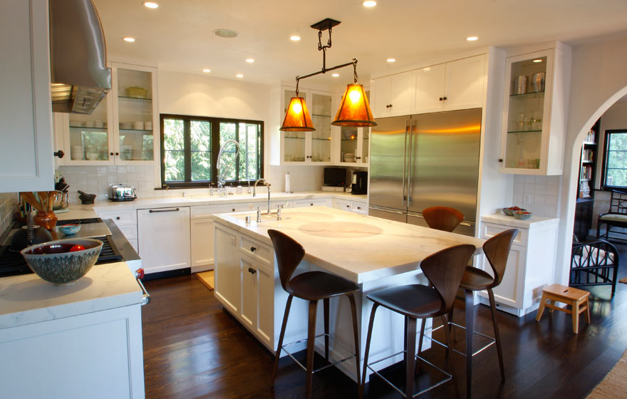 Brilliant white cabinetry is accented with a touch of metal and dark wood accessories. 