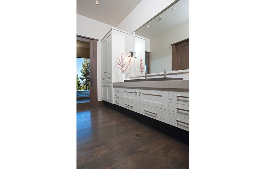 Crisp white paint brings a light, airy feel to this cabin's lower level bathroom.