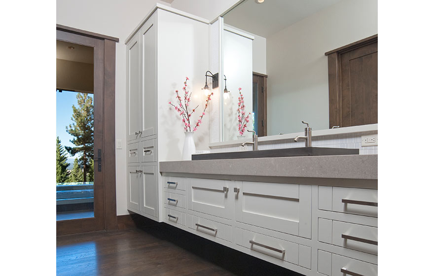 Crisp white paint brings a light, airy feel to this cabin's lower level bathroom.