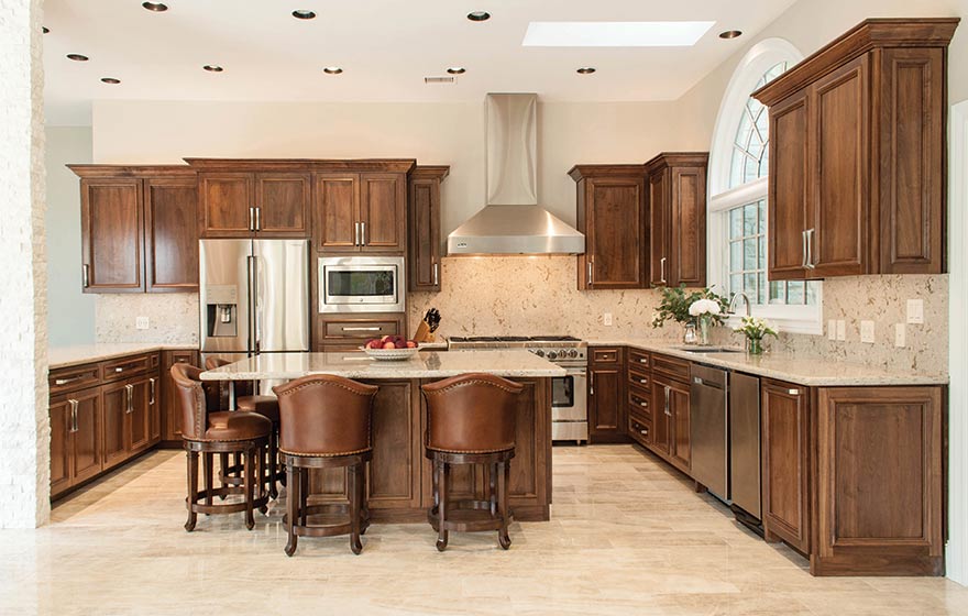 The warmth and beauty of Walnut Select material radiates elegance and class in this custom designed door kitchen.