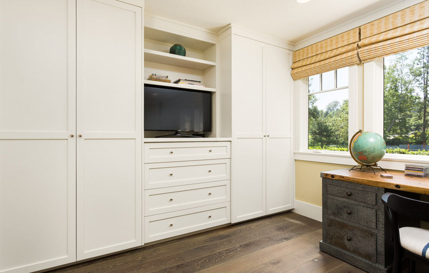 Plenty of built-in storage space provides a clean, organized look in this kid's room.