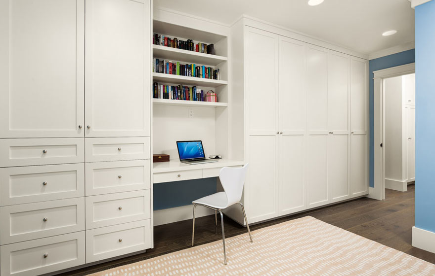 Built-in closets featuring hanging and folding space work wonders for organizing this kid's room. 