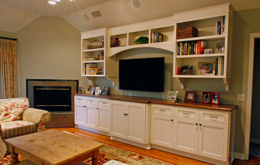 Pairing lower cabinets and upper shelving in entertainment areas provides a perfect balance of concealed storage and display space.